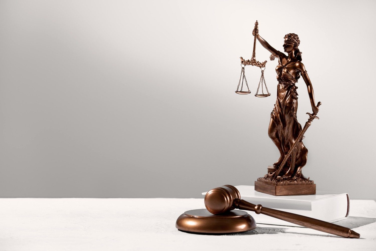 Scales of justice and a gavel on a desk